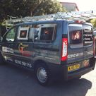 a campany van with coloured images in the panels and contact details on the doors