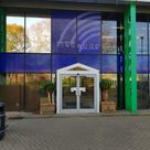 An external entrance to a leisure centre with printed window graphics of corporate logo